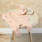 contents of baby girl gift box laid out in baby room