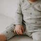 Baby wearing long sleeve organic romper with bunny print