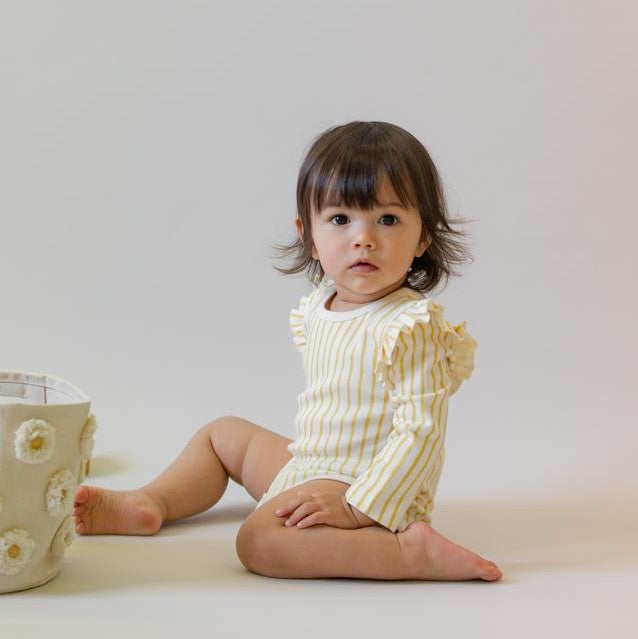 baby girl wearing yellow stripe organic cotton long sleeve onesie
