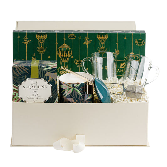 Anna & Amy gift box with tea, clear glass mugs, candle, snuffer and silver tea diffuser.