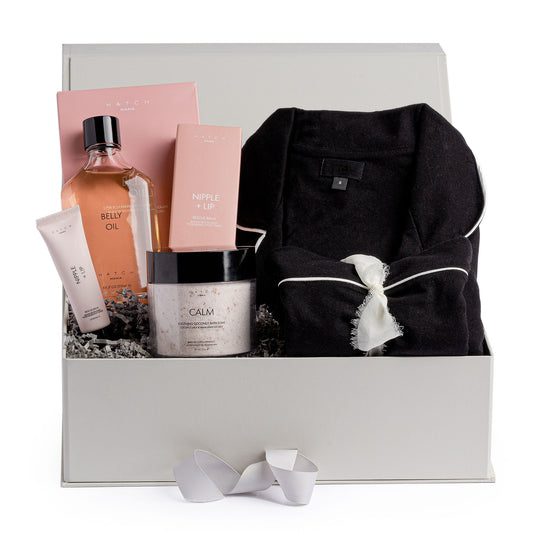 maternity gift box with sleepwear and body care such as belly oil, bath soak and nipple cream.